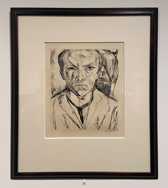 Framed woodcut portrait hanging in a museum